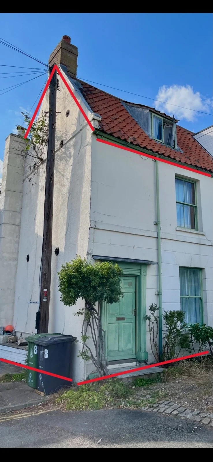 Before: the Norwich property with visible cracks in the render. Red annotations are retained from the supplied photograph.